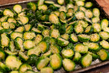 Close-up of  Seasoned Brussels sprouts on a metal tray 