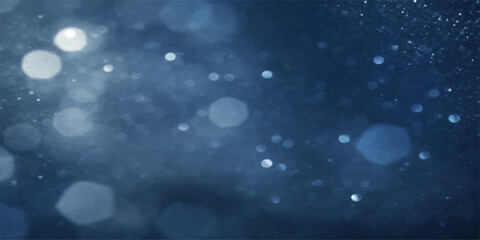 An abstract winter background featuring blue particles in the sky like falling snowflakes and magic stars to create a cold seasonal design for a Christmas holiday celebration card © PAGLAA