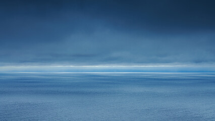 A panoramic aerial view of the Pacific Ocean with low-flying dense clouds obscuring the sky, Muroran, Hokkaido, Japan