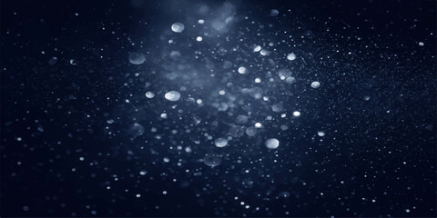 Abstract winter galaxy pattern with falling snow flakes and rain drops on a black background featuring blue night sky particles and starry cosmos light