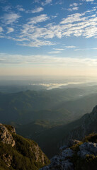 Scenic mountain landscape during sunrise with clouds and valleys  