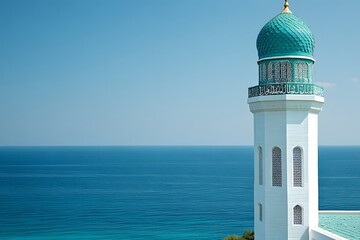 Tall white minaret with a turquoise dome overlooks vast expanse of deep blue ocean under clear sky