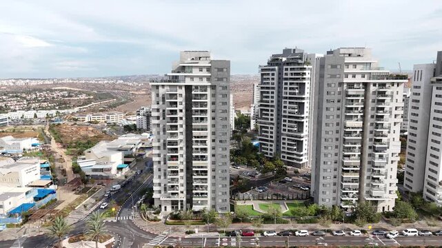 Aerial drone view of Afula, a city in northern Israel, showing urban neighborhoods, residential buildings, roads, and surrounding landscape. Modern Israeli cityscape captured from above, highlighting 