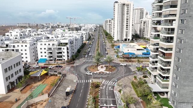 Aerial drone view of Afula, a city in northern Israel, showing urban neighborhoods, residential buildings, roads, and surrounding landscape. Modern Israeli cityscape captured from above, highlighting 