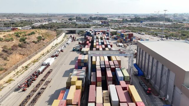 Aerial drone view of Ashdod Port in Israel with shipping containers, cargo ships and vehicle storage yards along the harbor. Industrial seaport showing global trade, import and export logistics, trans