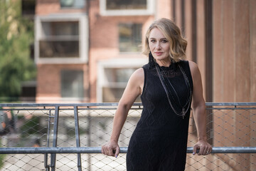Portrait of Beautiful White Caucasian Adult Woman She is Wearing Black Dress and Bijouterie on Neck. 