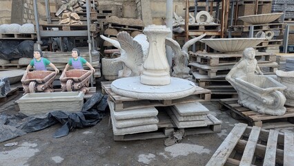 Craftsmen unwind amidst sand castings and sculpting debris