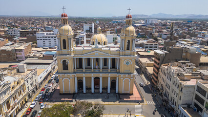Fototapeta premium Chiclayo’s Main Square featuring the iconic Cathedral, central fountain, green gardens, and a lively urban atmosphere that reflects the cultural and social heart of the city in northern Peru