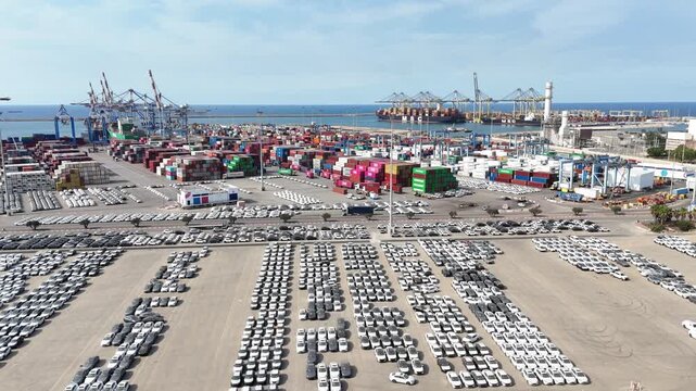 Aerial drone view of Ashdod Port in Israel with shipping containers, cargo ships and vehicle storage yards along the harbor. Industrial seaport showing global trade, import and export logistics, trans