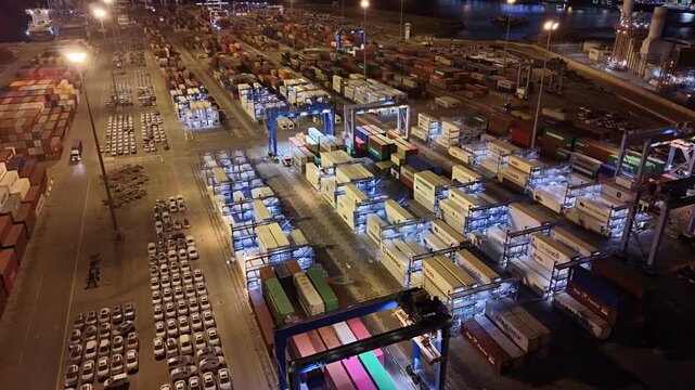 Aerial drone view of Ashdod Port in Israel with shipping containers, cargo ships and vehicle storage yards along the harbor. Industrial seaport showing global trade, import and export logistics, trans