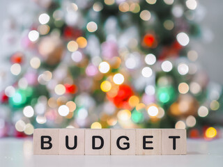 Wooden blocks with the word BUDGET with shiny light for Christmas background. The concept about budget planning and allocation