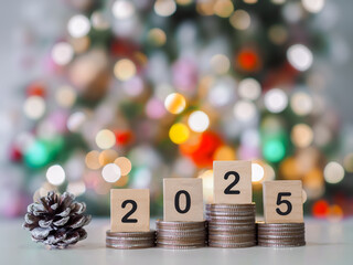 Close up of number 2025 on stack of coins and Christmas decorations with Christmas light background. The concept of saving money, Financial, Investment and Business growing in year 2025.