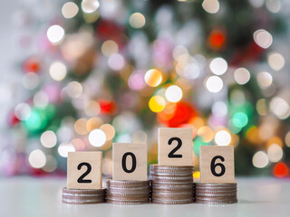 Close up of number 2026 on stack of coins with Christmas light background. The concept of saving money, Financial, Investment and Business growing in year 2026.