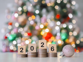 Close up of number 2026 on stack of coins and Christmas decorations with Christmas light background. The concept of saving money, Financial, Investment and Business growing in year 2026.
