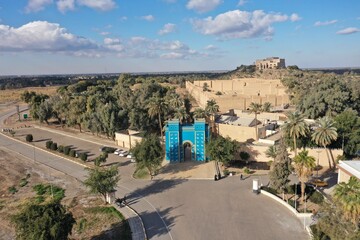 Panoramic overview of the ancient city of Babylon in Iraq, showing archaeological ruins and administrative buildings, highlighting the historical and cultural heritage of Mesopotamia