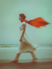 Woman walking along the beach with flowing red scarf and white dress, captured in soft motion blur, evoking freedom, calm emotion, coastal atmosphere, and cinematic minimalist mood.