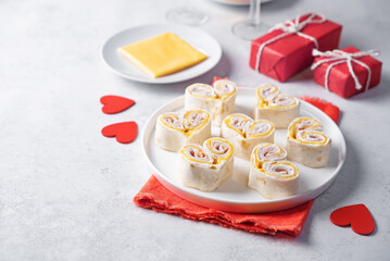 Ham Cheddar cheese cream cheese pinwheel in the form of hearts in a plate