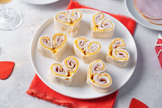 Ham Cheddar cheese cream cheese pinwheel in the form of hearts in a plate