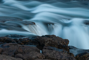 A small river flowing over rocks and stones, in Iceland