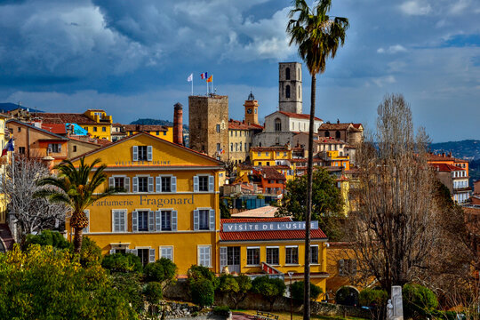 Grasse, France - February 12th 2018: View of the Fragonard Museum and perfume factory, with the cityscape in the background including the Notre-Dame du Puy Cathedral under clear, sunny skies.