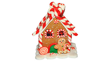 A festive holiday gingerbread house with colorful candy canes on top