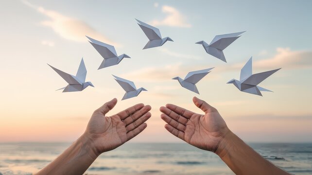 Hands Releasing Origami Doves into a Serene Sky