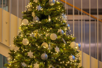 Christmas tree with white and silver ornaments and lights
