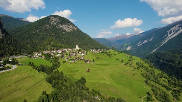 Aerial panoramic view around the village and mountains of Schmitten in Switzerland on a sunny day in summer.