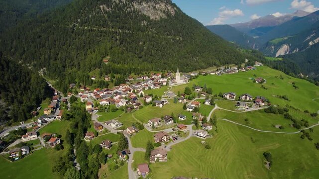 Aerial panoramic view around the village and mountains of Schmitten in Switzerland on a sunny day in summer.