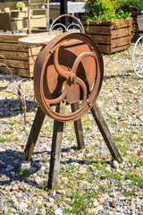 Rusty old wheel sits on a wooden base