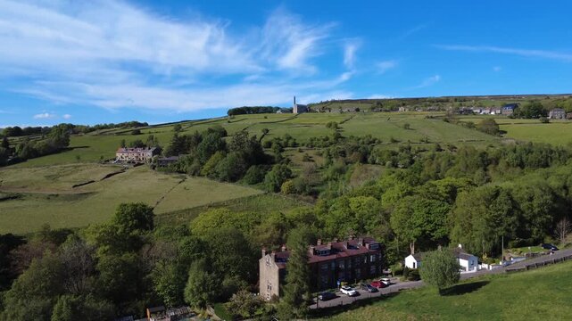 scenic aerial drone view of the old town area of hebden bridge from sandy gate lane with the old mill in summer sunlight