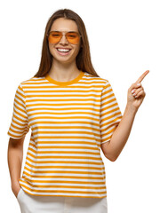 Smiling woman in yellow striped t-shirt and orange sunglasses pointing finger at empty copy space