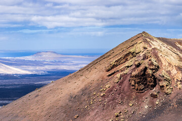 Lanzarote volcanic landscape with ocean and clouds forming a travel concept
