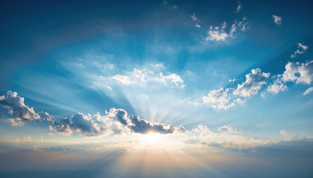 Beautiful blue sky with dramatic sunbeams shining through fluffy white clouds during a serene sunset, creating a majestic and hopeful heavenly scene