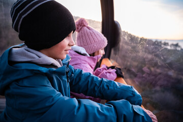 Children enjoying cable car ride with winter scenic view © Zoran Jesic