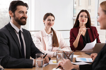 Businesspeople working together at table in office