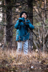 Fototapeta premium Young boy exploring winter forest nature smiling
