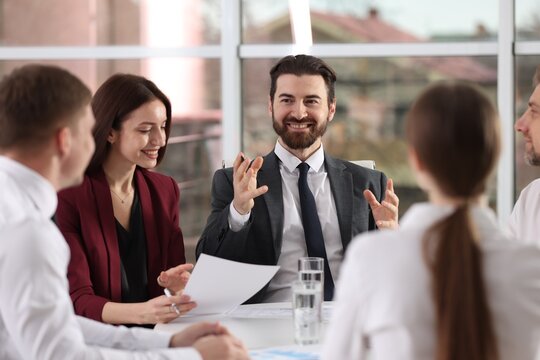 Businesspeople working together at table in office - Powered by Adobe