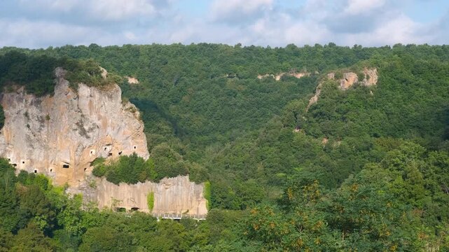 Etruscan necropolis carved into a cliff in blera italy. Sunlight moving across the ancient etruscan necropolis of pian del vescovo carved into the tufa rock cliffs of blera, a archaeological site