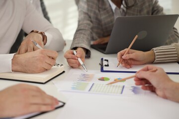 Businesspeople working together at table in office, closeup