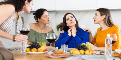 Woman shares her problems with her friends. They calm her down