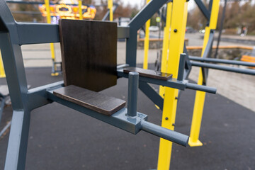 A black and yellow gym equipment. The black part is a bench