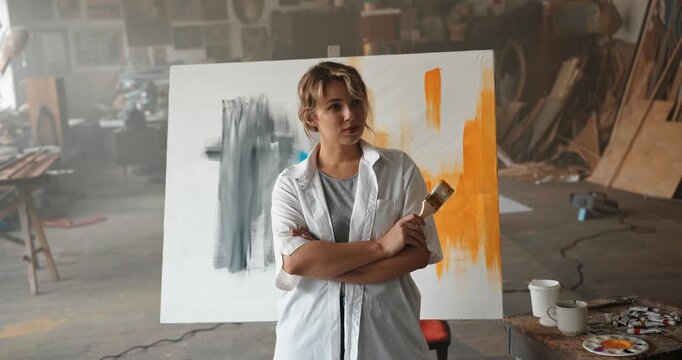 Female artist posing in her creative studio