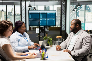 African american candidate signing employment contract during interview with HR manager and...