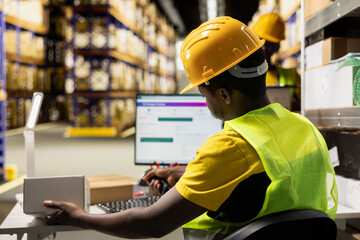 Retail distribution hub staff scanning barcode awb labels on boxes at the warehouse desk, processing orders for express delivery. Registering shipment numbers with scanner for tracking info.