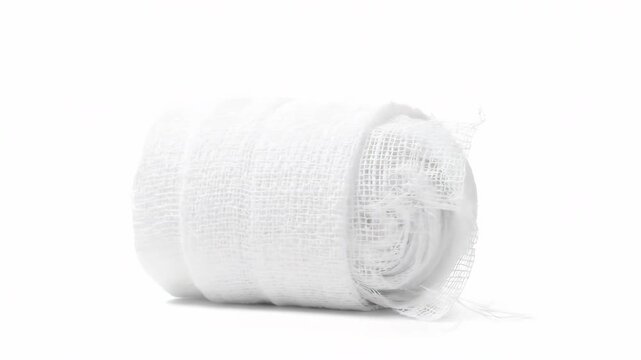 Close-up view of a pristine white rolled medical gauze bandage set against a clean white backdrop, highlighting its texture, and sterile condition.