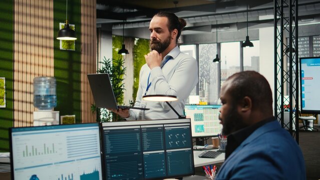 Office administrator completing daily tasks and monitoring work efficiency, utilizing data insights on infographics to generate performance reports and statements for management solutions.