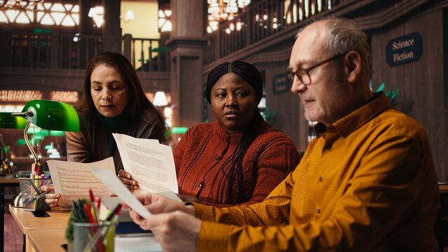 Cast members practicing script reading for a classic drama play in a library, showing dedication to acting and passion for character development. Theatrical arts role play.