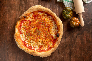 Freshly baked neapolitan margherita pizza on rustic table