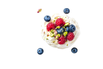 Perfect mini Pavlova cake with whipped mascarpone cream and fresh berries slices sprinkled with crushed pistachios and almond top view isolated on whit